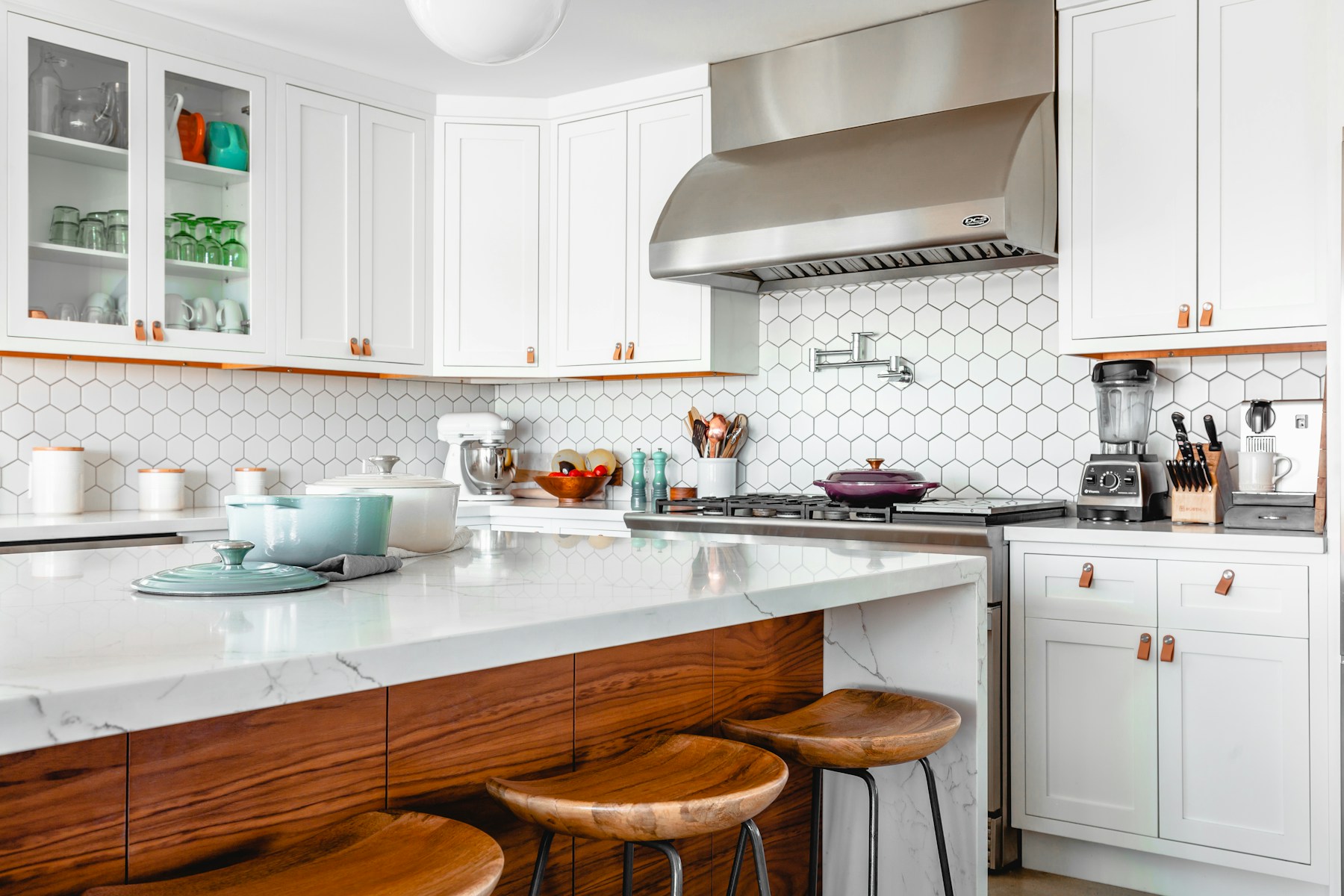 Bright kitchen with white cabinetry and polished countertops